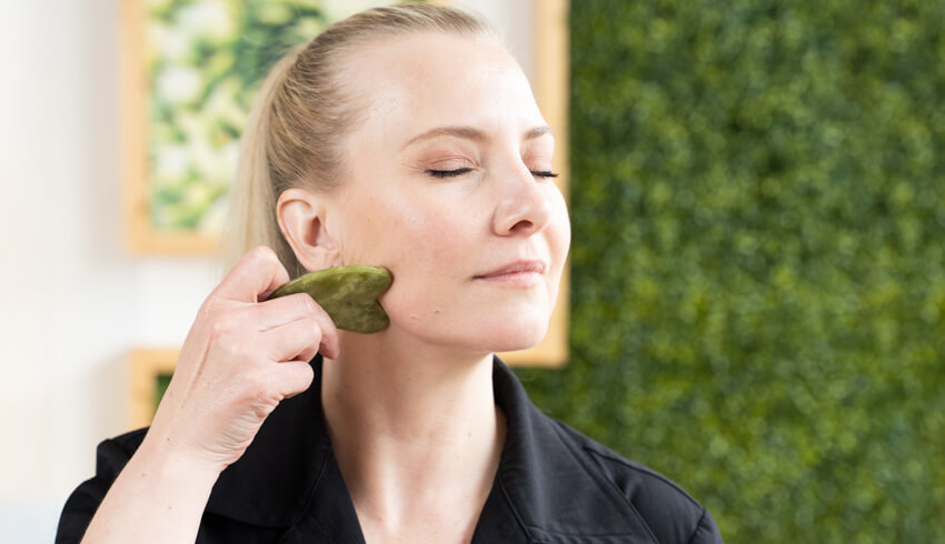 Woman using a gua sha tool